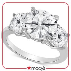 three stone engagement ring in white gold with diamonds on the sides and an oval diamond center