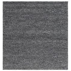 a gray rug with black and white dots on the bottom, it is made out of wool