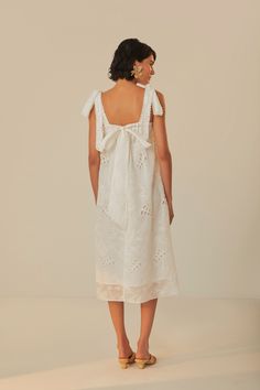 Embrace the soft allure of the Off-White Midi Dress from FARM Rio. This enchanting piece features feminine eyelet embroidery that dances across a delicate off-white fabric. With its square neckline and charming ruffle-trimmed straps, this dress exudes a romantic touch. The relaxed silhouette falls gracefully to mid-calf, and the lovely bow detailing at the back ensures a sweet exit. Perfect for sunny days or moonlit strolls, it’s a dress that whispers of daydreams and gentle elegance. Composition 65% COTTON 30% LYOCELL 5% POLYESTERCare Instructions HAND WASH SEPARATELY, DO NOT BLEACH. DO NOT TUMBLE DRY, LINE DRYING, IRON AT LOW HEAT, DO NOT DRY CLEANSize and Fit Inches XXS XS S M L XL Bust 30 32 33 3/4 35 3/4 39 42 1/4 Waist N/A N/A N/A N/A N/A N/A Length 38 1/4 39 39 2/4 40 1/4 41 41 2/4 Eyelet Embroidery, Casual White Dress, White Midi, Farm Rio, White Midi Dress, White Fabric, White Fabrics, Square Neckline, Mid Calf