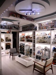 a room filled with lots of shelves covered in figurines and other items on display