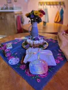 a table topped with a vase filled with flowers