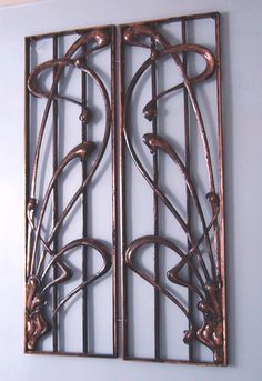 a decorative metal screen mounted to the wall