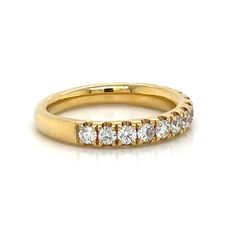 a yellow gold wedding band with five diamonds