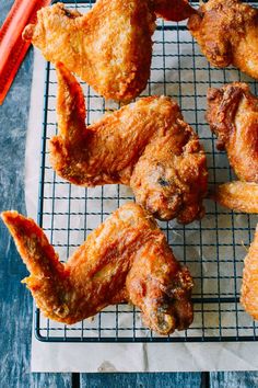 fried chicken wings on a cooling rack with carrots