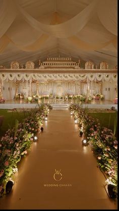 an indoor wedding venue decorated with flowers and candles