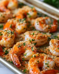 shrimp with parmesan cheese and herbs in a baking pan