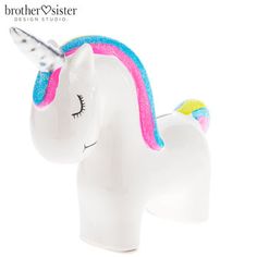 a white ceramic unicorn figurine with a rainbow colored mane and horn on it's head