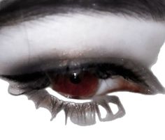 an extreme close up shot of a woman's eye with blood on the iris