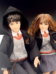 two dolls dressed in school uniforms sitting next to each other