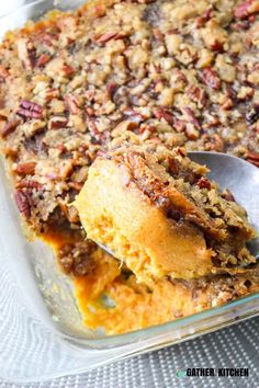 a close up of a spoon in a casserole dish with food on it