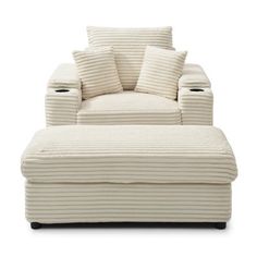 a white chair and ottoman with pillows on the bottom, in front of a white background