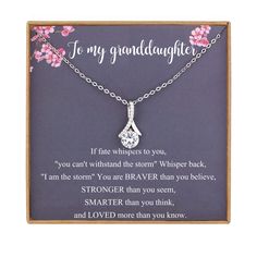 a necklace with a poem on it that says, to my granddaughter and i love you more than you know