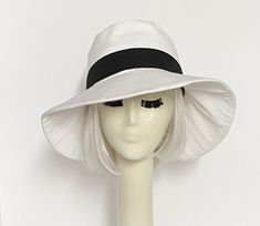 White cotton poly blend twill wide brim sun hat, the crown is 3 1/2 " in length with a black contrast band and a one piece 4" brim, lined in a rayon print with 1" soft black cotton band. One size fits most up to 23" Machine wash / dry Press if needed / packable Made in USA Beret Hat Bow, Black And White Hats, Chanel Hat, Disney Hats, Hat Stores, Distressed Hat, Wide Brim Sun Hat, Black Baseball Cap, Denim Hat