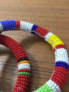 "Here is a set of three (3) gorgeous bangle bracelets from the Maasai tribe in Kenya. Black seed beads are accented with gold geometric pattern and colorful stripes. Bracelets measures approx. 2-1/2\" inside diameter. A wonderful gift to give to that someone special or to keep for yourself! NOTES: ~I make every attempt to list and picture any flaws within all of my item descriptions, such as any prominent chips, cracks, stains, discoloration or missing elements. Please refer to pictures, as they African Beaded Bracelets, Gold Geometric Pattern, Hand Beaded Necklace, Beaded Bangles Bracelets, Native American Necklace, Glass Bead Bracelet, Bead Bangles, Black Seed, Maasai