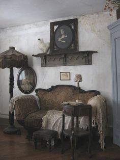 an old fashioned living room with antique furniture