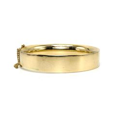 B.A. Ballou was founded in 1868 and continues to produce jewelry today. It is one of the oldest extant manufacturers of American jewelry. This lovely bangle is made of 14 karat yellow gold (the clasp is stamped "14K B.A.B.") and features a safety chain, which ensures the bracelet remains on the wearer should its clasp fail. This clasp is tight as new and the bracelet comes pre-engraved with a trigram that reads "MSM." Metal: 14K Yellow Gold Inside Diameter: 2.5 in. (average size) Vintage Etched Yellow Gold Bangle, Vintage Adjustable Brass Bangle, Vintage Gold-tone Bangle Bracelet, Vintage Yellow Gold Brass Bangle, Vintage Hinged Bangle Bracelet, Safety Chain, American Jewelry, Hinged Bangle, Hinges