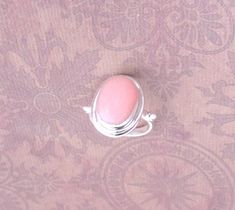 "Gorgeous pink Opal on a solid 925 sterling silver setting. Colorful, romantic, delicate rings.  Measures approx. 3/4\" x .52\" x 1/4\" H  Light pink and rose-pink tones of genuine Opal for you to choose your favorite.  Rose Pink is just a little darker.    * Made of genuine gems and color variations may occur but are all gorgeous!" Fine Jewelry Pink Cabochon, Pink Ring With Bezel Setting, Pink Bezel Set Ring, Pink Bezel Set Ring Jewelry, Pink Round Stone Promise Ring, Pink Sterling Silver Opal Ring For Anniversary, Classic Pink Cabochon Rings, Pink Sterling Silver Jewelry With Center Stone, Pink Opal Ring In Sterling Silver For Anniversary