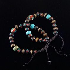 Tibetan Traditional Bracelet  (The Namaste Collection). Handcrafted Yak bone Prayer beads 8-9mm. Each bead is hand-painted and crafted in Tibetan Tradition. The center bead is handmade with brass, Turqoise and Coral. The 2 Turquoise beads on side are for GOOD LUCK. The brown waxed cord is finished with macrame knot.  Adjustable up to 10 inches (25cm) with slip knot closure. Crafted in Tibetan Traditions  Namaste. Prosperity Bracelet, Tibetan Bracelet, Tahitian Pearl Necklace, Yoga Mala, Lapis Lazuli Bracelet, Tahitian Black Pearls, Kids Bracelets, Rose Quartz Bracelet, Macrame Knot