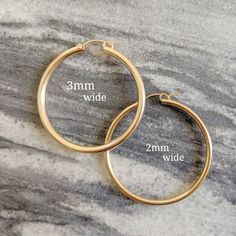 * ZOOM for better detail * Water safe The classic hoop earrings, they'll never go out of style. These hoops measure 2mm in width! ♥️ Sold individually or as a bundle. FEATURES: - 14k Gold Filled MEASUREMENTS: - Hoops measure (from smallest to largest): .75 inch, .90 inch, and 1.2 inch. Medium Hoop Earrings, Real Gold Jewelry, Big Hoop Earrings, Gold Filled Hoops, Gold Chain Necklace, Jewelry Cleaner, Dainty Jewelry, Go Out, Out Of Style