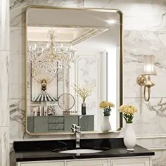 a bathroom vanity with a large mirror above it and flowers in vases on the counter