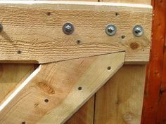 a wooden door with metal knobs on it