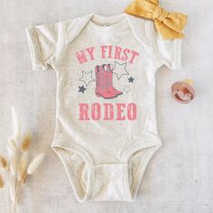 My First Rodeo Outfit, Rodeo Birthday, Baby Bodysuit,  First Birthday Outfit, Birthday Girl Shirt, First Birthday Shirt G A R M E N T ∙ F E A T U R E S : * Uniquely soft fabric * Modern, unisex fit * Crew neck and short sleeves - Has a great comfortable fit you are sure to love F I T ∙ & ∙ S I Z I N G * Please consult size chart in pics for accurate fit. Please keep in mind that there are always slight variations in sizing. - Remember unisex tee's fit on the bigger side. F A B R I C A T I O N: * COTTON C R A F T S M A N S H I P ∙ & ∙ L O V E * We hand press each item with non-toxic material. * Machine wash in cold water, inside out, and tumble dry. - We assure quality in each one of our pieces. My First Rodeo Outfit, First Rodeo Outfit, 1st Rodeo, Rodeo Outfit, Rodeo Girls, First Birthday Shirt