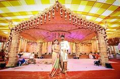 a man and woman standing in front of a decorated stage