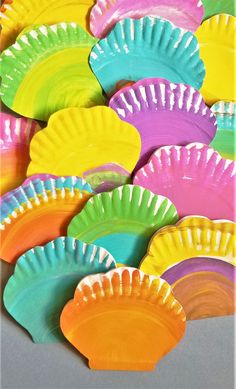 there are many colorful paper plates on the table