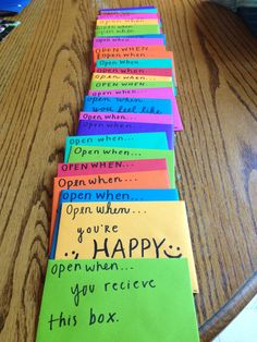 a bunch of post it notes sitting on top of a wooden table next to each other