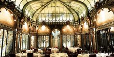 an ornate dining room with tables and chairs