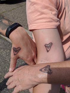 two people with matching tattoos on their arms