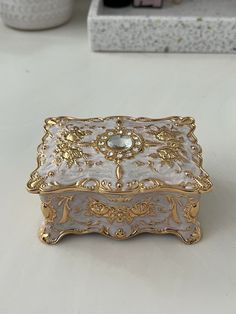 a white and gold box sitting on top of a table