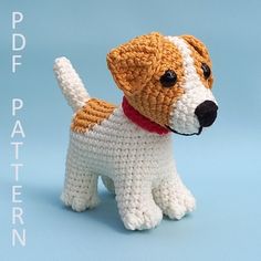 a crocheted dog with a red collar on it's neck and tail