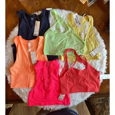 Urban Outfitters Out From Under Crop Top And Tank Top Haul New With Tags Includes 6 Items: 1. Navy V Neck Ribbed Tank- Size L 2 &3. Green And Pink Crop Top Detailed Cross Bralette/Top- Size M-L 4. Light Yellow Bralette Size S 5. Hot Pink Crop Tank Zip Up- Size M-L 6. Orange V Neck Ribbed Tank- Size M Pet Friendly Smoke Free Home Multicolor Stretch Tops For Day Out, Stretch Multicolor Tops For Day Out, Casual Neon Cotton Tops, Urban Outfitters Multicolor Cotton Top, Urban Outfitters Multicolor Tops For Day Out, Vibrant Sleeveless Tops For Spring, Vibrant Sleeveless Spring Tops, Vibrant Tops For Day Out, Urban Outfitters Multicolor Summer Tops