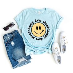 Looking for a cute versatile top to wear this summer? Make sure to grab one of our Happy Days Ahead Smiley Face tees! This soft and comfortable graphic tee is the perfect top for any outfit. It can be paired with biker shorts, jeans, or even a simple skirt/dress! This tee is true-to-size, so be sure to order your regular t-shirt size! If you are looking for a more oversized look, make sure to size up! Smiley Face Tee, Mauve Blush, Baby Boy Toys, Happy Days, Cable Knit Cardigan, Boutique Brands, Sweater Blouse, Smiley Face, Ice Blue