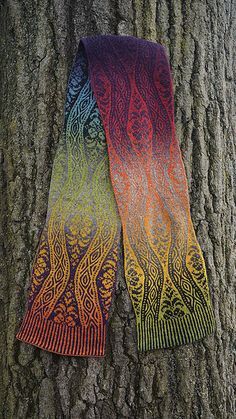 two scarves are hanging on a tree