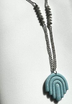 Listing for one handmade polymer clay necklace. Arch shaped pendant made with blue sparkly silver leaf polymer clay. White howlite bead accent.  Hypoallergenic chain with lobster clasp closure. Boho Arch, Handmade Silver Jewelry, Blue Clay, Titanium Quartz, Quartz Pendant Necklace, Polymer Clay Necklace, White Howlite, Metal Leaves, Clay Necklace