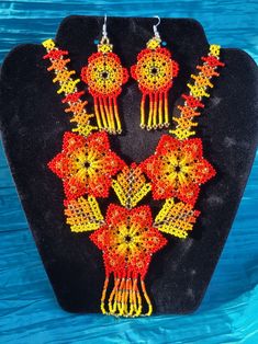 Gorgeous Handcrafted Huichol Necklace Set | 3 Flower That Forms a Heart| Necklace and Earrings|    You will be amazed by the beautiful bead work of this handcrafted necklaces, all with beautiful unique bright colors and patterns.  They are handmade by very talented Mexican Artisans in Chiapas, Mexico. They represent their beautiful culture and hardwork.  wear it with pride! *This necklace has double face, can be weared both sides *Set includes Necklace and Earrings Beautiful Culture, Necklace And Earrings Set, Handcrafted Necklace, Necklace And Earrings, Hama Beads, Double Face, Earrings Set, Heart Necklace, Necklace Set