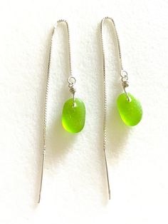 Petite genuine sea glass dangles in bright green on 4" sterling silver box chain threaders.  Genuine tumbled beach glass pebbles from the beaches of Northern California are wire wrapped in sterling silver on 4" sterling silver box chain threaders. Total length is 4 1/2". Lightweight and summery. Perfect pop of bright green! Also available on 14k gold fill 3 in. box chain threaders. Total length is 3 3/4 in. Green Adjustable Chain Jewelry For Beach, Green Jewelry With Adjustable Chain For Beach, Green Dangle Jewelry For The Beach, Adjustable Dangle Sea Glass Jewelry, Silver Box, Threader Earrings, Box Chain, Bright Green, Tumbling