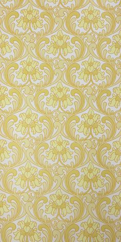 a yellow and white wallpaper with an intricate design