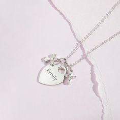 If you're looking for a meaningful gift for a young girl that can be engraved to mark her initials or a special life event, then look no further! This heirloom, engravable heart charm necklace is as special as it gets. Adorned with a protective cubic zirconia guardian angel charm and cross, this personalized heart charm for young girl's is simply perfect. Every part of this necklace set is hand crafted in genuine 925 sterling silver, making it hypoallergenic and suitable for children & teens wit Anniversary Heart Charm Initial Pendant, Anniversary Heart Charm With Initial Pendant, Anniversary Heart Charm And Initial Pendant, Personalized Silver Charm Necklaces For Keepsake, Personalized Silver Charm Necklace For Keepsake, Birthday Silver Name Necklace With Heart Charm, Silver Birthday Name Necklace With Heart Charm, Personalized Sterling Silver Heart Pendant Charms, Personalized White Gold Charm Necklaces For Personalized Gift