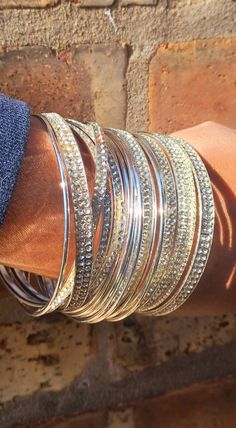 These are unqiue  silver  Large and chunky size  boho style They are very lightweight  The circumference is 2 3/4 wide on the solid bangles  20 total bangles  These will fit most large wrist size They look great layered or worn individually  Great addition to any unique wardrobe Bohemian Silver Stackable Cuff Bracelet, Silver Stackable Bohemian Cuff Bracelet, Bohemian Silver Metal Bangle, Bohemian Silver Cuff Bracelet For Parties, Silver Bohemian Cuff Bracelet For Party, Silver Bling Cuff Bangle Bracelet, Silver Stackable Metal Bangle, Silver Metal Bangle For Party, Silver Stackable Bangle Cuff Bracelet