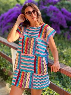 a woman wearing sunglasses and a crocheted dress