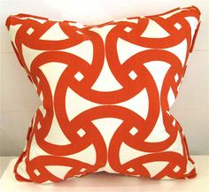 an orange and white pillow on a table