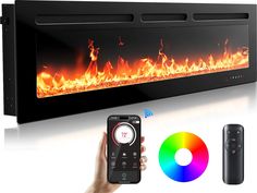 a person holding a remote control next to a wall mounted fireplace with flames on it