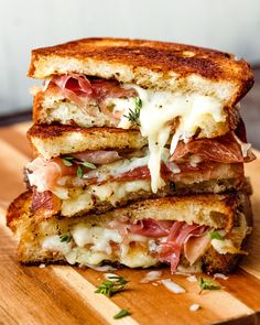 a grilled cheese and ham sandwich on a cutting board