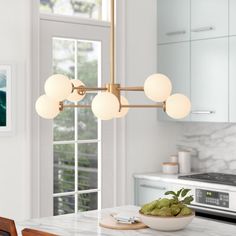 a modern kitchen with marble counter tops and an island in front of the window is shown