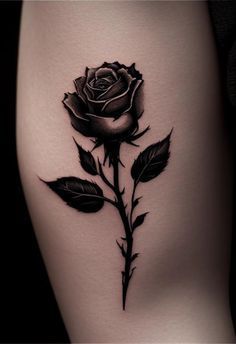 a black rose tattoo on the thigh