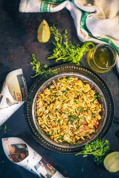 a bowl filled with rice and vegetables next to other food items on a black surface