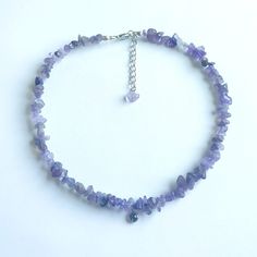 Enhance your everyday or festive look with this elegant handmade beaded necklace. Each necklace is crafted with meticulous attention to detail, adding a unique cultural charm to your style. This piece is perfect for your wardrobe or as a delightful gift for lovers of unique accessorie. This handmade necklace features genuine amethyst chips paired with shimmering purple beads. It includes an adjustable clasp for a perfect fit and offers customization options to suit your preferences. Made with st Purple Gemstone Beads Necklace For Festivals, Beaded Crystal Necklaces As Gift, Adjustable Dangle Crystal Necklace With Faceted Beads, Round Beaded Mineral Crystal Necklaces For Gifts, Beaded Mineral Crystal Necklaces As Gift, Beaded Mineral Crystal Necklace As Gift, Mineral Crystal Beaded Necklace With Round Beads As Gift, Adjustable Mineral Crystal Beaded Necklace As Gift, Festival Crystal Necklaces With Round Gemstone Beads